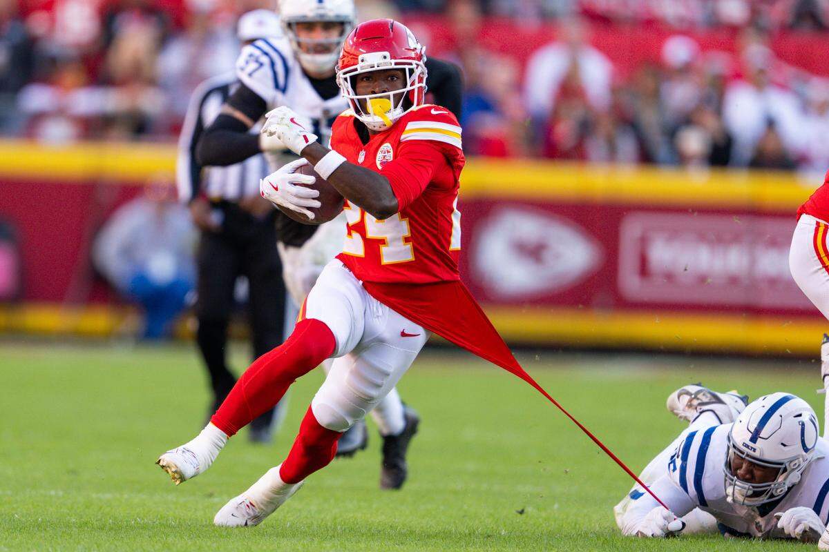 Kansas City Chiefs running back Brashard Smith (24) breaks a tackle as a Indianapolis Colts player pulls his jersey in the second half of the Chiefs game against the Indianapolis Colts on Sunday, November 23, 2025, at GEHA Field at Arrowhead Stadium.
