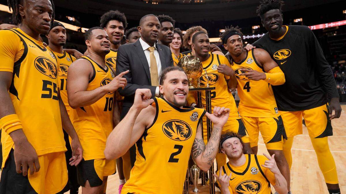 Members of the Missouri men’s basketball team celebrate after defeating Illinois on Thursday, Dec. 22, 2022, in St. Louis.