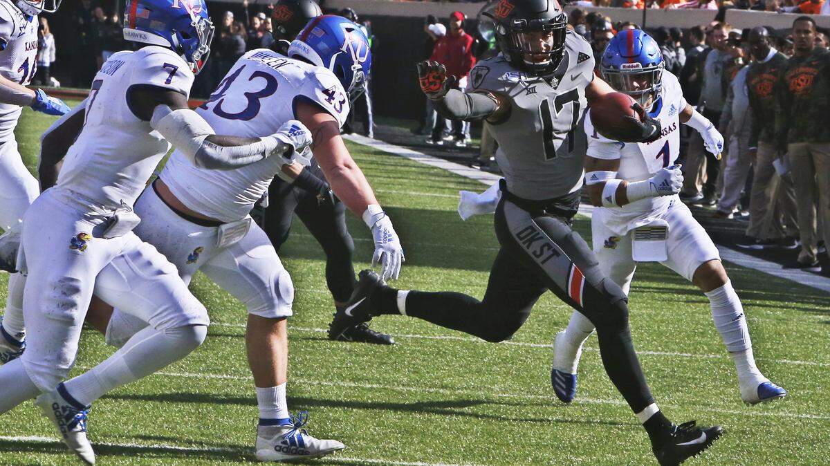 Oklahoma State wide receiver Dillon Stoner (17) carries against Kansas in the first half of an NCAA college football game in Stillwater, Okla., Saturday, Nov. 16, 2019. (AP Photo/Sue Ogrocki)
