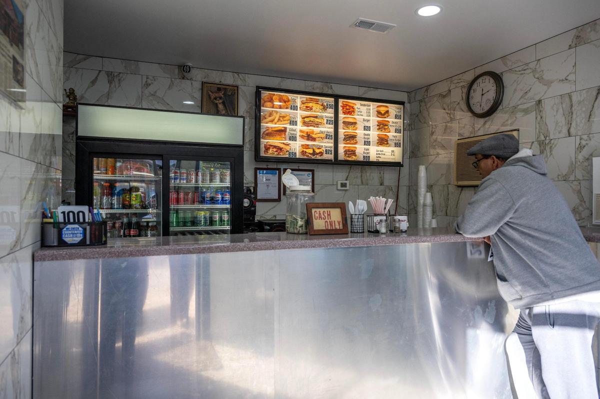 A guest waits by the counter to be served at Kitty’s Cafe on Thursday in Kansas City.