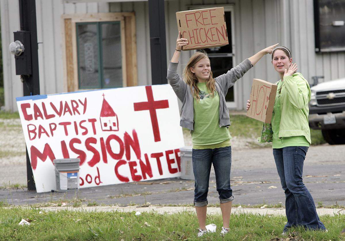 Volunteers Hailey Riesenmy (left) and Alison Sauer directed people in for free food.