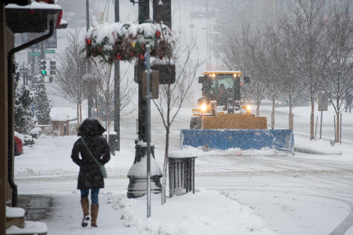 A plow truck works on the Country Club Plaza Sunday after an early winter snow storm hit the Kansas City area.