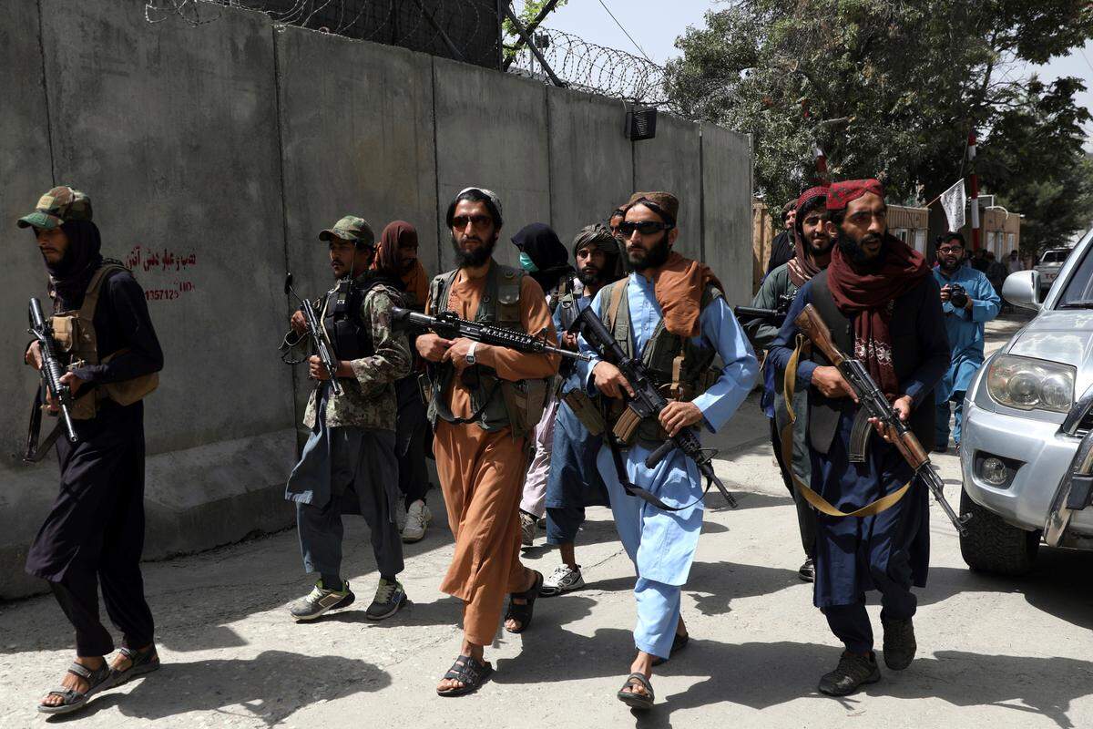 Taliban fighters patrol in Wazir Akbar Khan neighborhood Wednesday in the city of Kabul, Afghanistan. The Taliban declared an “amnesty” across Afghanistan and urged women to join their government Tuesday, seeking to convince a wary population that they have changed a day after deadly chaos gripped the main airport as desperate crowds tried to flee the country.