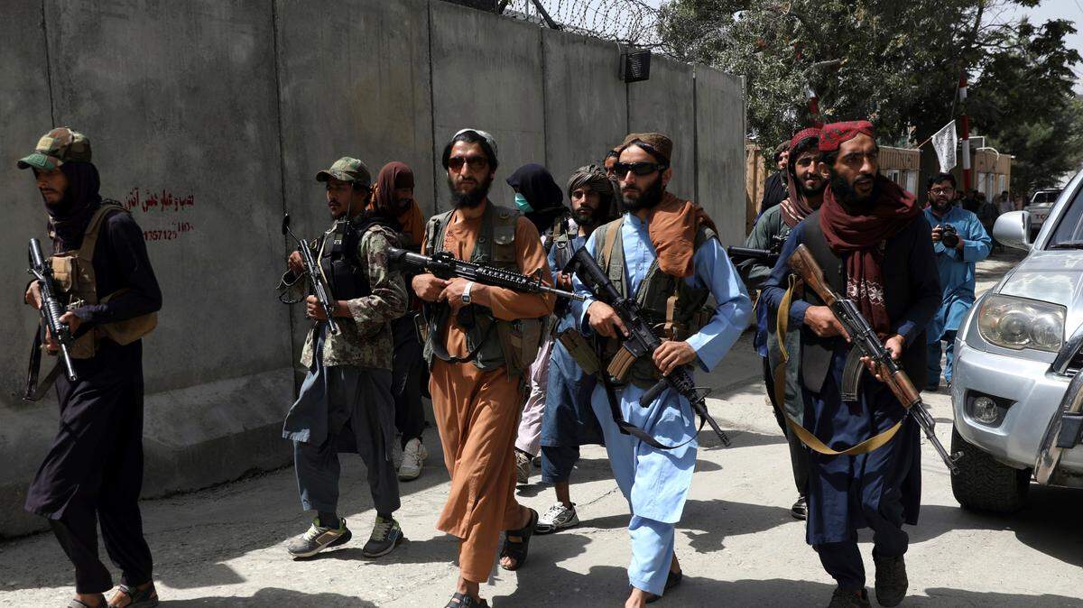 Taliban fighters patrol in Wazir Akbar Khan neighborhood Wednesday in the city of Kabul, Afghanistan. The Taliban declared an “amnesty” across Afghanistan and urged women to join their government Tuesday, seeking to convince a wary population that they have changed a day after deadly chaos gripped the main airport as desperate crowds tried to flee the country. 