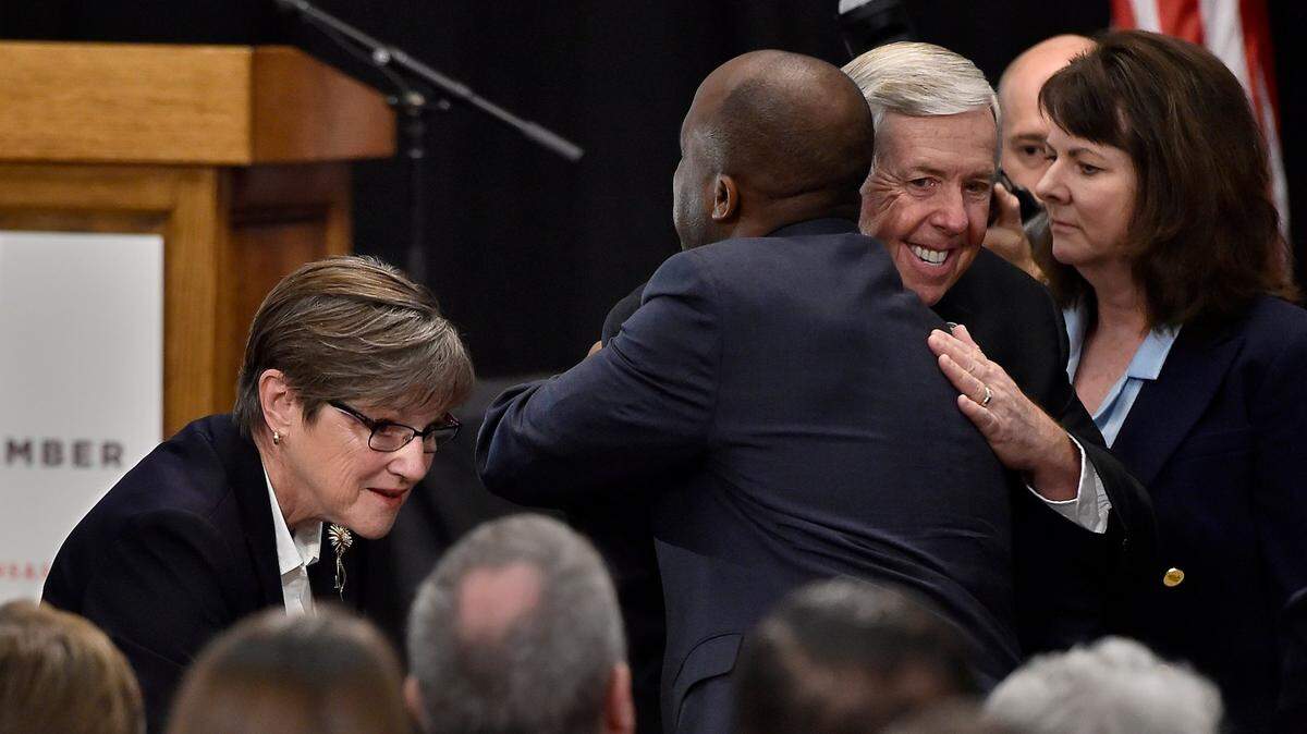 Kansas Gov. Laura Kelly and Missouri Gov. Mike Parson appeared at a Governors Summit for Regional Collaboration Tuesday, Aug. 13, 2019, at Memorial Hall in Kansas City, Kan., to sign an agreement ending the economic border war between the two states. As they made their arrival, Kelly, left, greeted guests and Parson, third right, and Kansas City, Missouri, Mayor Quinton Lucas hugged.