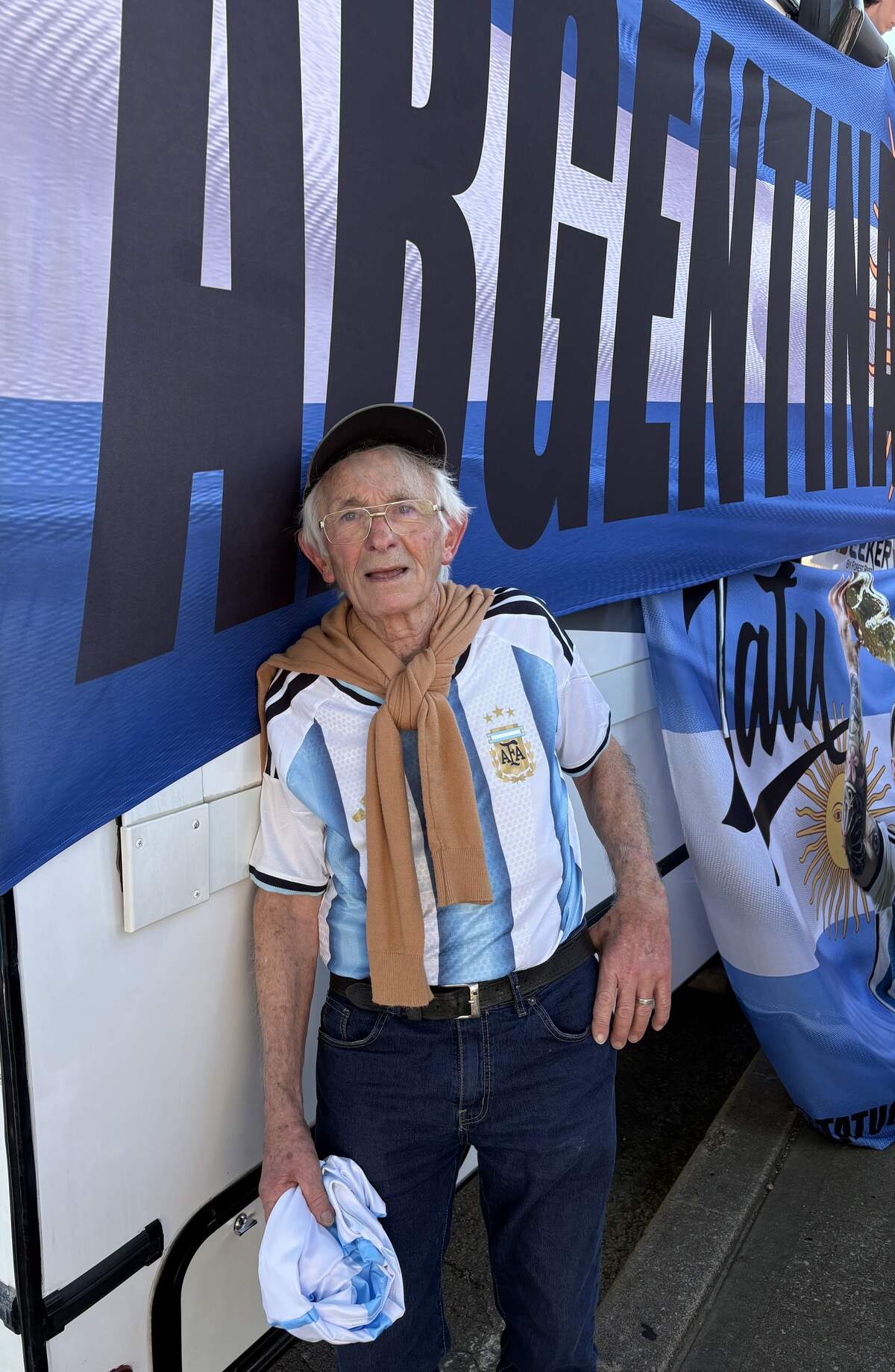 Angel Berrado stands in the shade at the Kansas City “banderazo.” The 76-year-old Argentinian traveled to his fourth World Cup with his son.