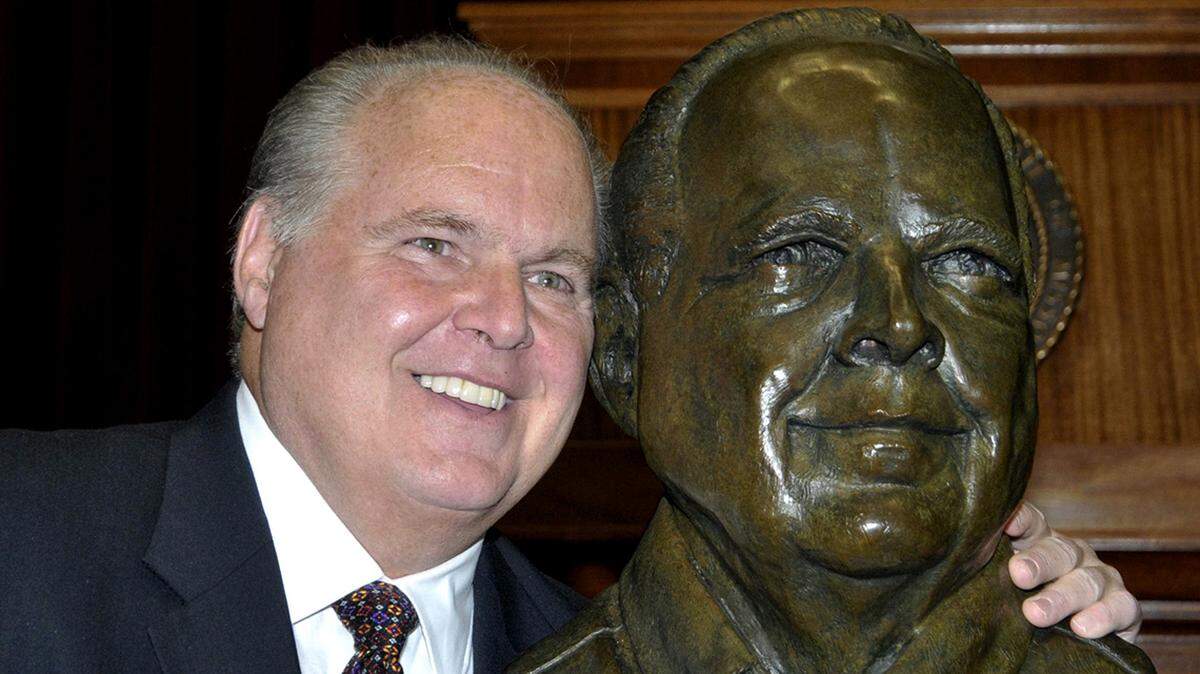 Conservative commentator Rush Limbaugh poses with a bust in his likeness during a secretive ceremony inducting him into the Hall of Famous Missourians on Monday, May 14, 2012, in the state capitol in Jefferson City, Missouri.