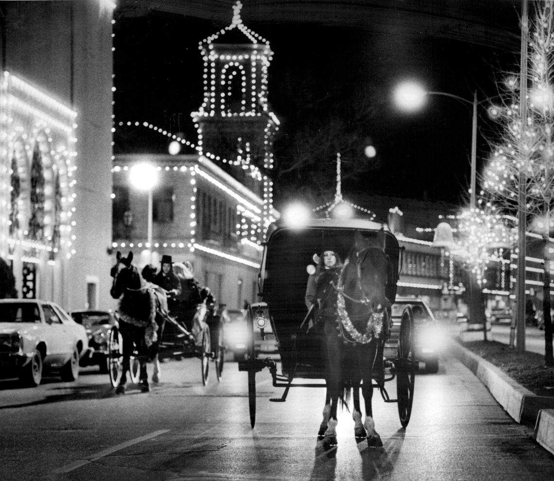 A carriage glides through the Country Club Plaza under the glow of holiday lights in 1979, an idea brought to life by Mary Green. She and her daughter, Cherrie Green, offered the nostalgic rides.