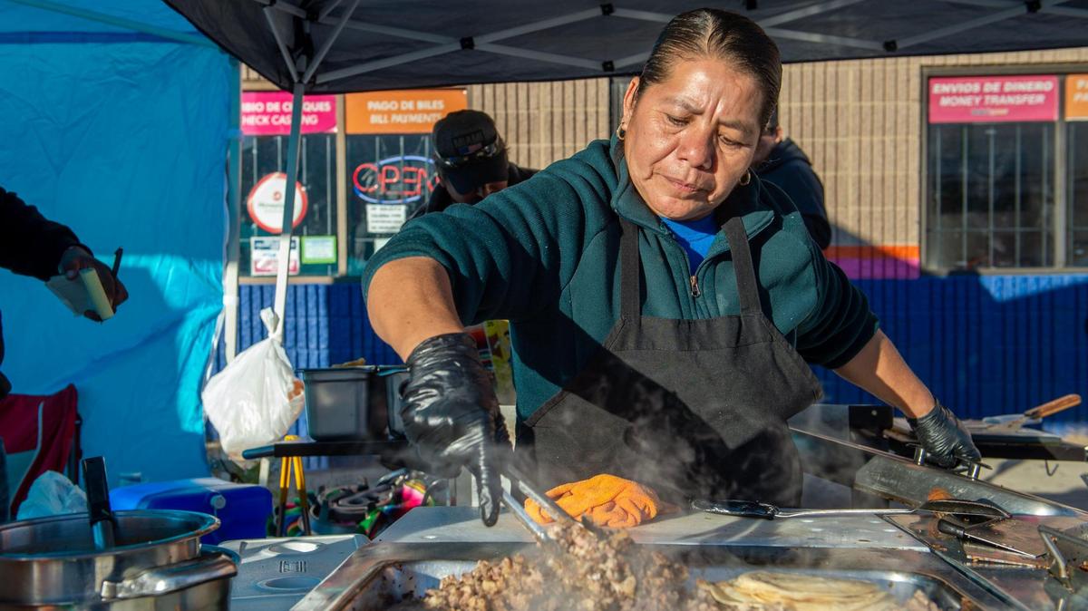 Agipina Garcia prepares to make a steak taco at the Tacos Pina booth during a 2022 Dia de Los Muertos celebration in Kansas City, Kansas.