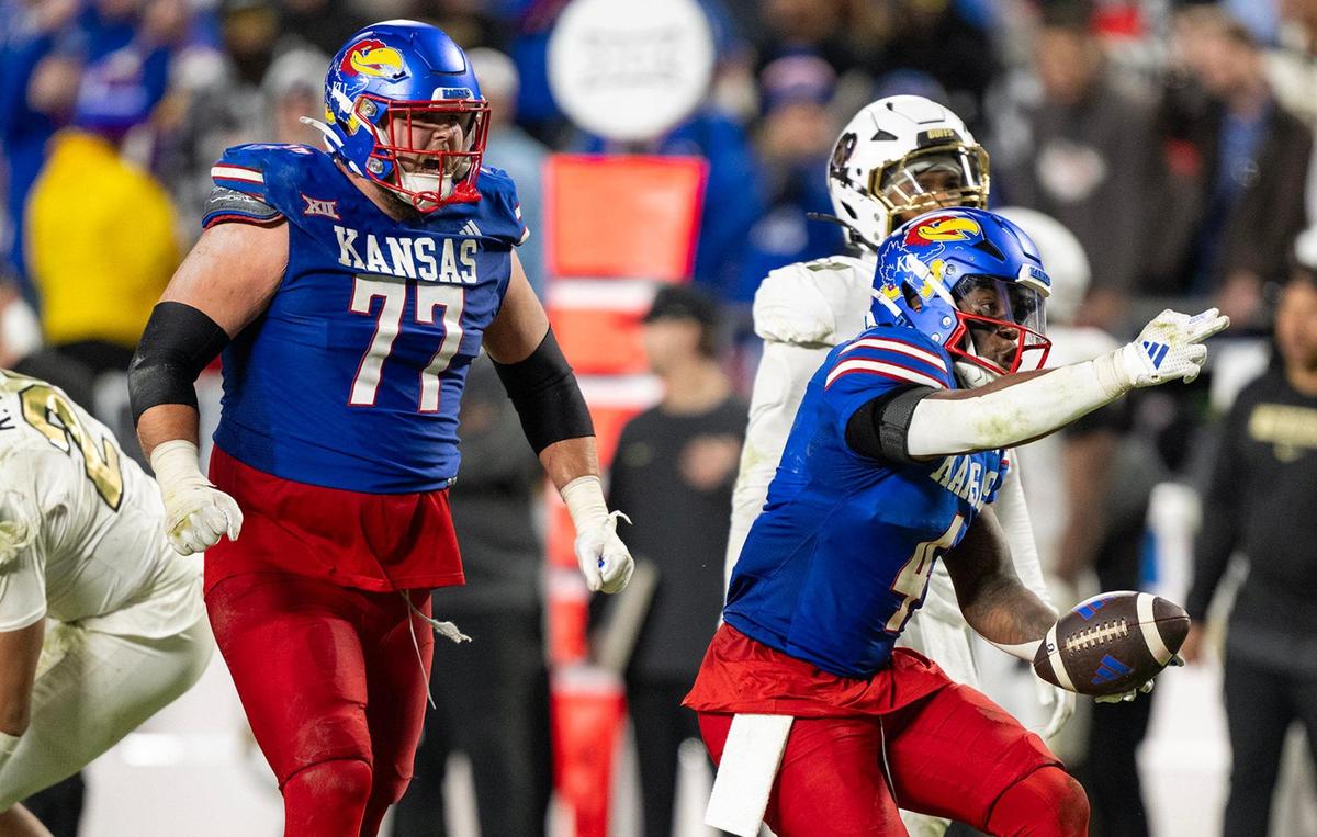 Kansas Jayhawks offensive lineman Bryce Cabeldue (77) was fired up as running back Devin Neal (4) signals for a first down in the second half against the Colorado Buffaloes at GEHA Field at Arrowhead Stadium on Saturday, Nov. 23, 2024, in Kansas City.
