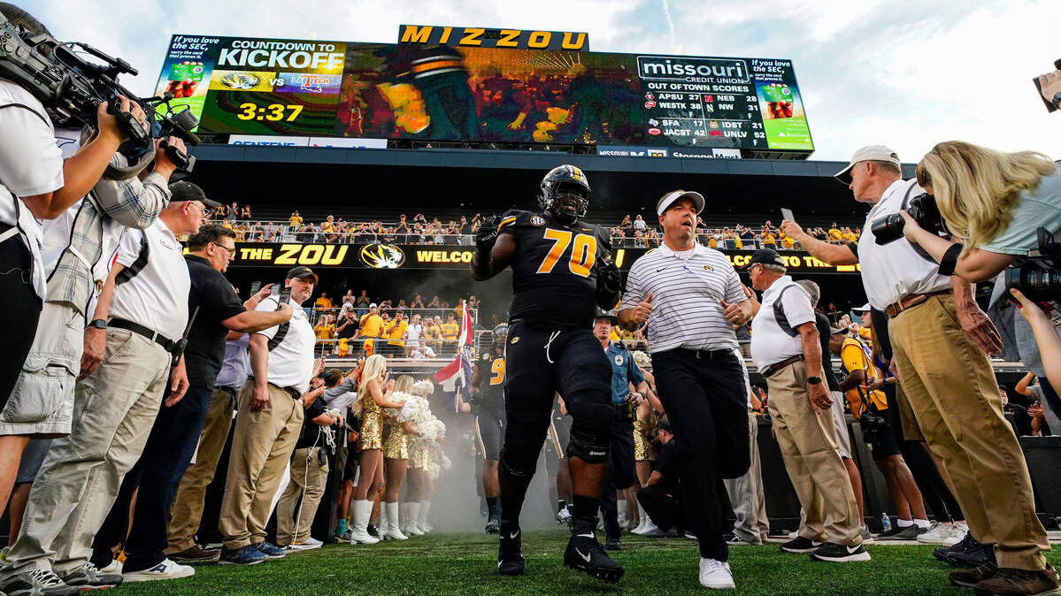 Missouri Tigers head coach Eliah Drinkwitz and offensive lineman EJ Ndoma-Ogar (70) take the field prior to a game against the Louisiana Tech Bulldogs at Faurot Field at Memorial Stadium on Sept. 1, 2022.