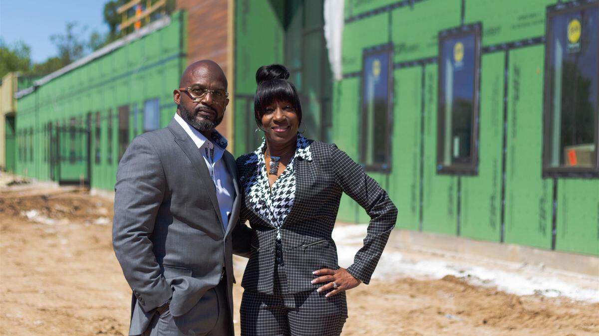 Myron McCant and Penny Dale-McCant, in front of the KD Academy as it was under construction.