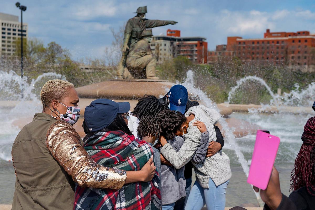 The family of Billy Birmingham, an EMT with the Kansas City Fire Department who died from complications of COVID-19, watched the Firefighters Fountain and Memorial in Penn Valley Park spring to life in his memory. Birmingham was the first line-of-duty death in Kansas City related to the coronavirus pandemic. Family members include (from left) daughter Octavia Standley, wife Mary Birmingham, son Bill Birmingham and his four children. File photo April 2020.