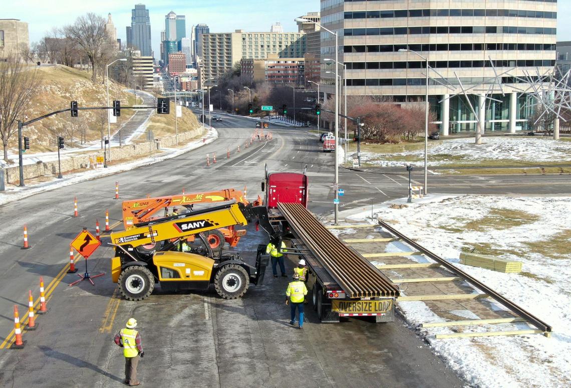The first delivery of rails for the KC Streetcar Main Street Extension were delivered to the construction site at 27th and Main streets where workers guided the rails onto wood beams as they were unloaded on Tuesday, Jan. 4, 2022, in Kansas City. Over a four-week period, 458 sticks of rails, each 80 feet long and weighing 3,100 pounds, will be delivered for the construction of the streetcar extension which will take about two-and-a-half years.