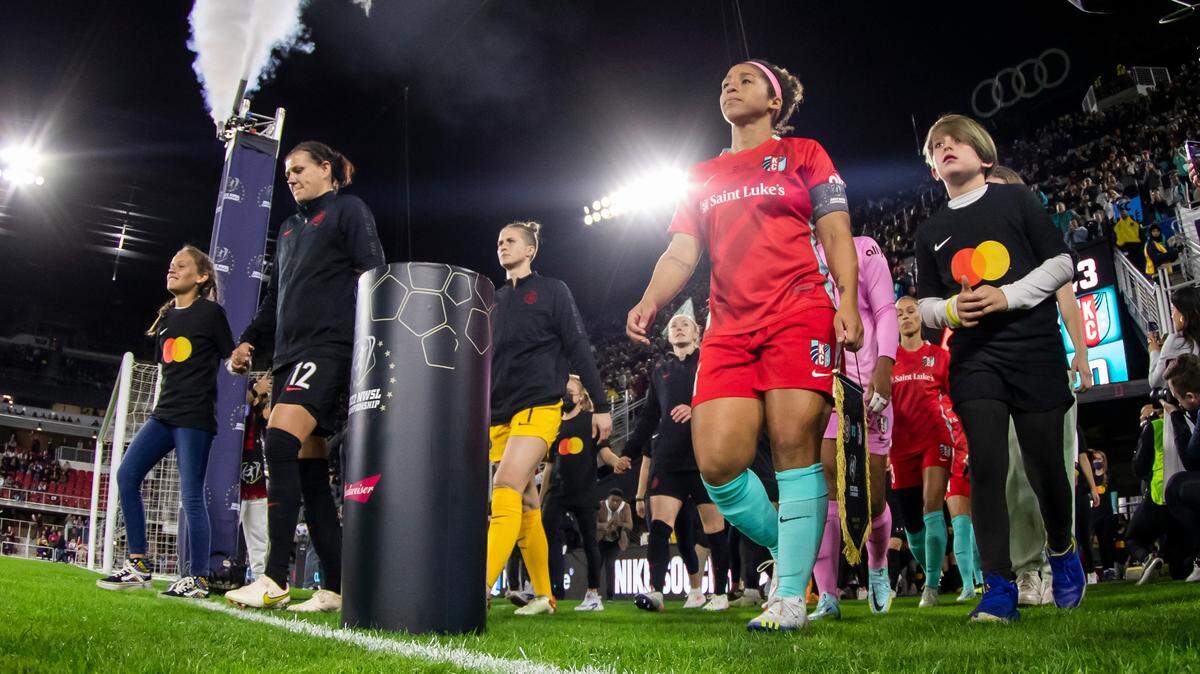 KC Current midfielder and captain Desiree Scott leads her team onto the pitch to play the Portland Thorns during the 2022 NWSL championship match at Audi Field in Washington D.C.
