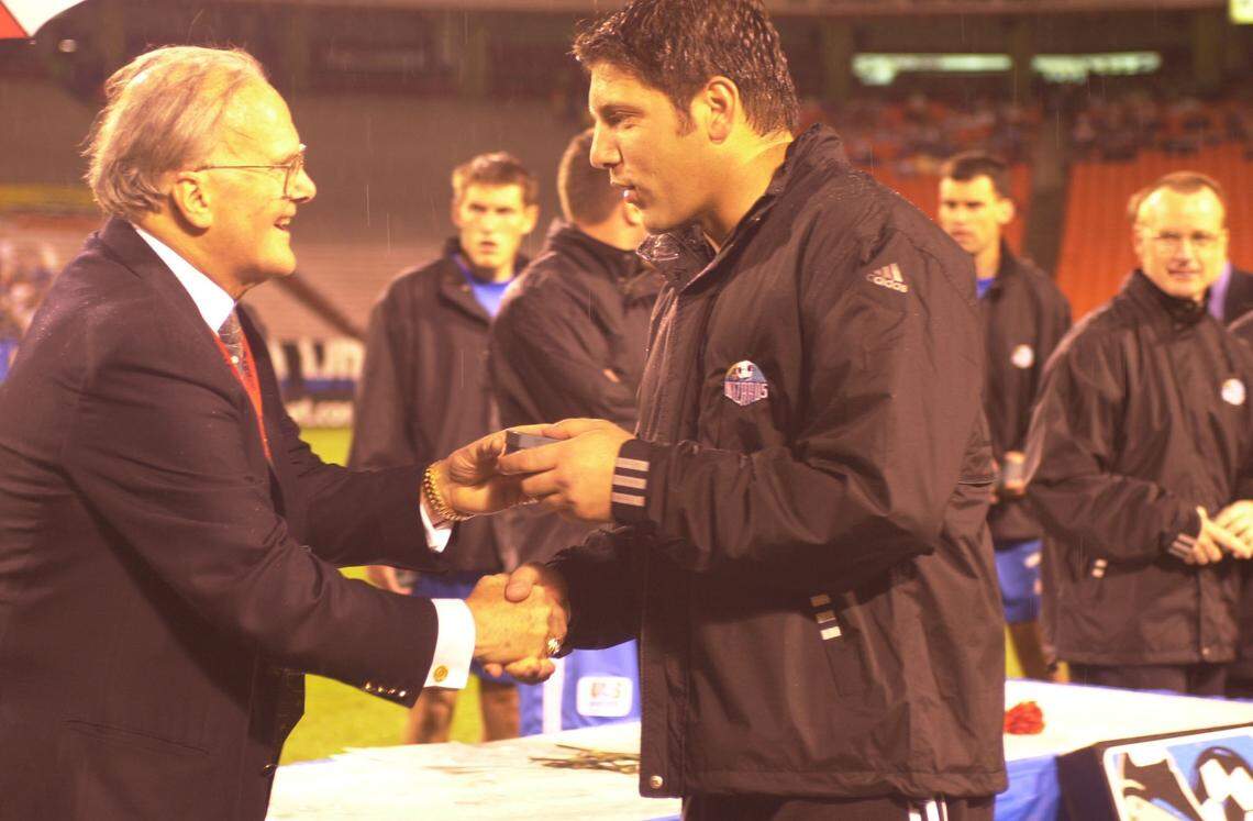 Lamar Hunt, left, presented Wizards goalkeeper Tony Meola with a championship ring during a ceremony held some time after the Kansas City club won soccer’s MLS Cup.