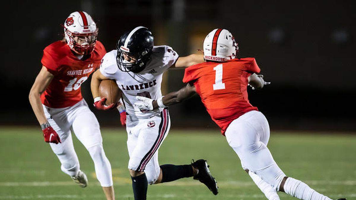 Lawrence senior wide receiver Sam Sedo breaks into the open field in the Lions’ 44-14 win at Shawnee Mission North Friday night.