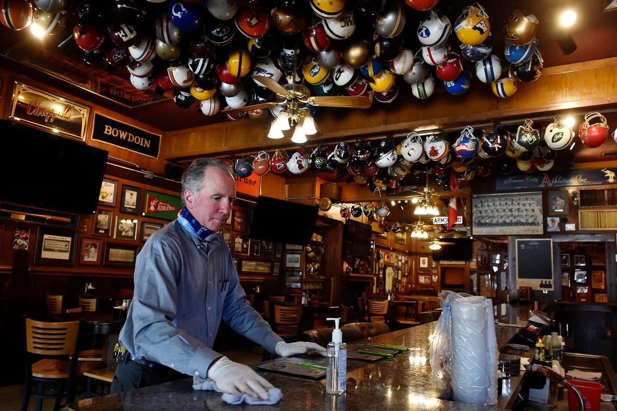 Social distancing reminders are placed around Chappell’s Restaurant and Sports Museum in North Kansas City. General manager Angelo Gangai sanitized the counter Thursday after a customer stopped in to pick up food.