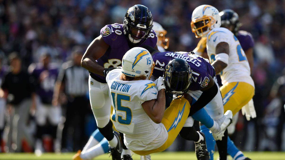 Los Angeles Chargers’ Jaylon Guyton is tackled by Baltimore Ravens’ Brandon Stephens on a punt return during the second half of an NFL football game, Sunday, Oct. 17, 2021, in Baltimore. The Ravens won 34-6. (AP Photo/Gail Burton)