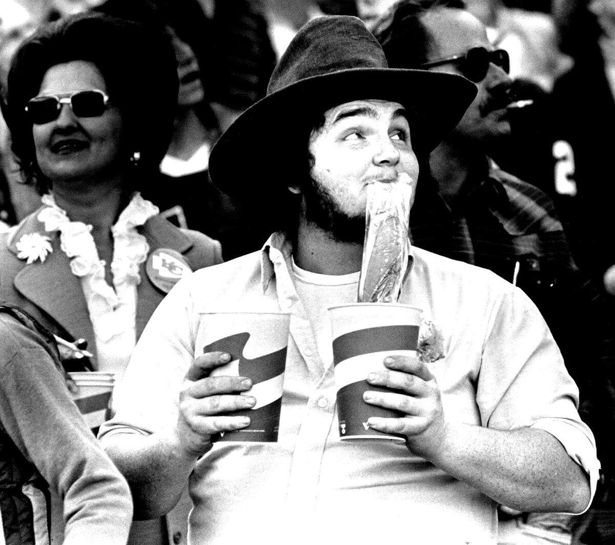 Checking the scoreboard at Arrowhead Stadium in this 1980 photo, Curtis Hopper, Kansas City, Kansas, returns to his seat from the concession stand. The Chiefs also had their hands full and lost to the Baltimore Colts, 31-24.