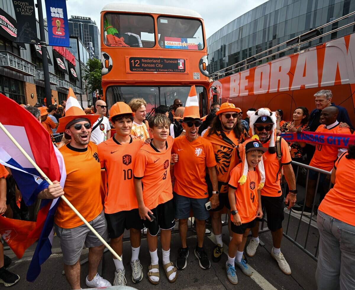 Dutch fans from Colorado gather in front of the Oranje Bus ahead of the Netherlands Orange Walk from Kansas City's Power & Light District to FIFA Fan Fest on June 25, 2026.