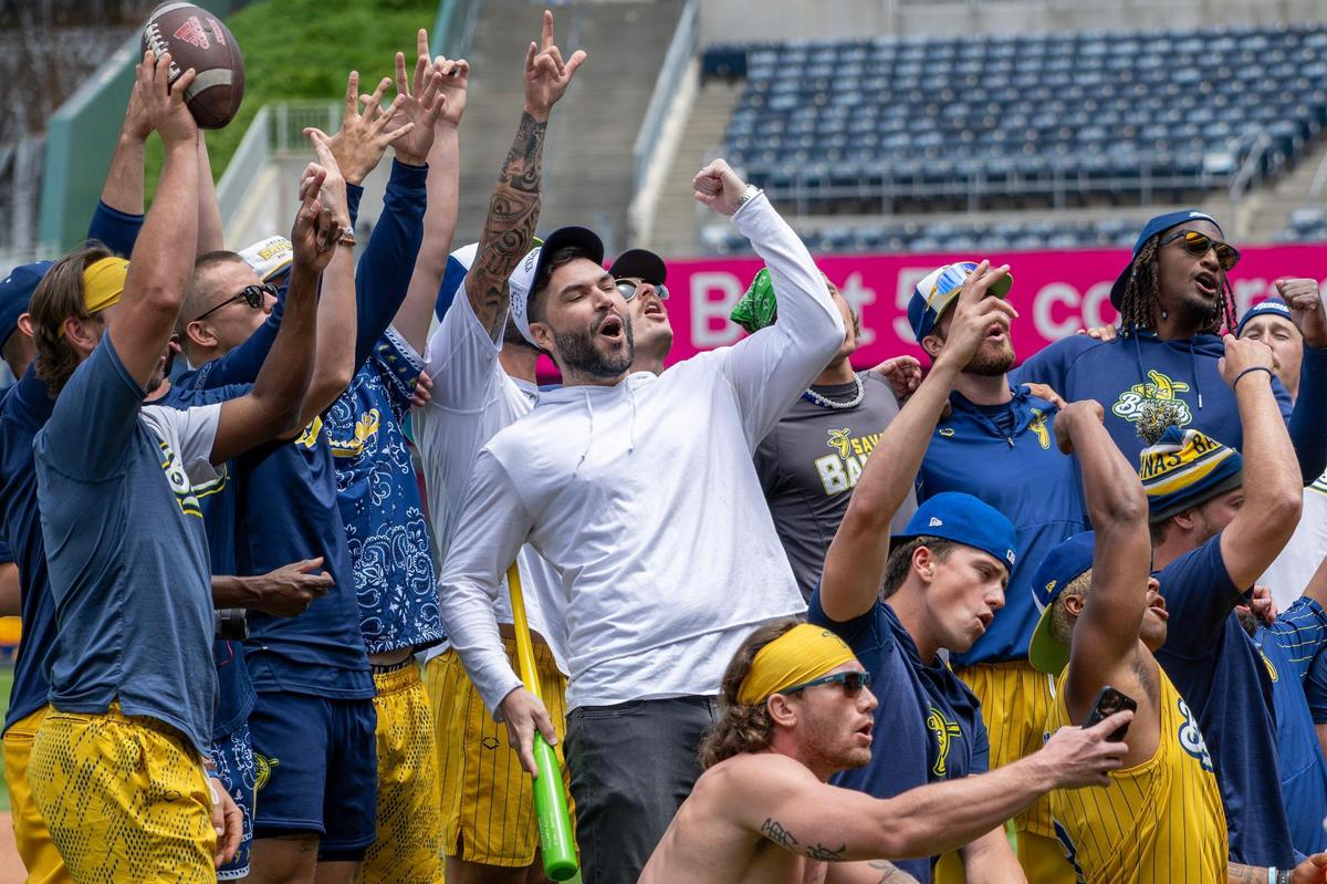 Former Kansas City Royals player Eric Hosmer practices a dance routine with Savannah Bananas players before the Banana Ball game. He later took the field.
