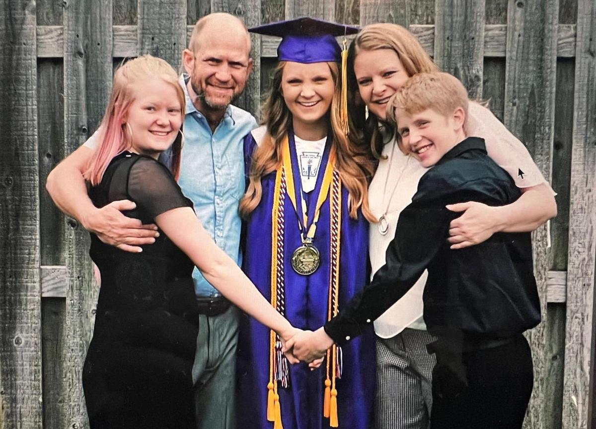 Haylee Weissenbach (center) is surrounded by her family, including her parents Scott and Jenny Weissenbach, and her sister Jayden, left, and brother, Camden, after she graduated from McLouth High School in 2019.