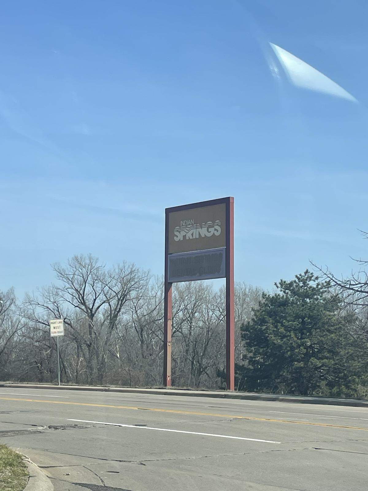 A sign at the edge of the former site of Indian Springs still bears the mall’s name on the afternoon of March 20, 2026. The sign remains about 10 years after the mall’s 2016 demolition.