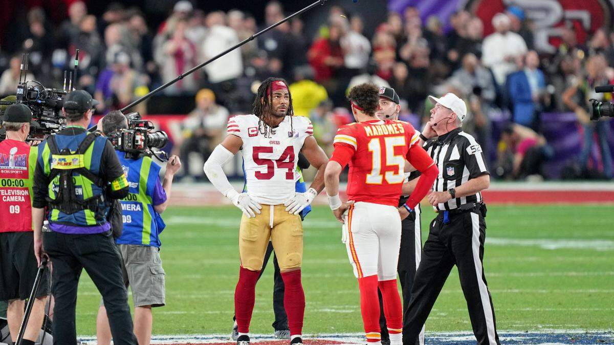 San Francisco 49ers linebacker Fred Warner (54) and Kansas City Chiefs quarterback Patrick Mahomes (15) during the coin toss before overtime of Super Bowl LVIII at Allegiant Stadium.