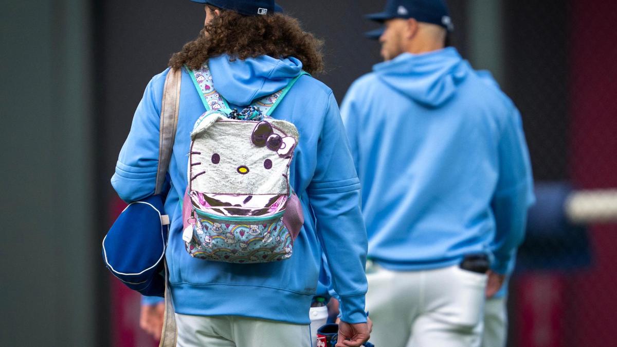 Kansas City Royals pitcher Andrew Hoffmann (54) carries a Hello Kitty backpack to the bullpen before the start of the game against the Detroit Tigers on Friday, May 30, 2025, at Kauffman Stadium in Kansas City.