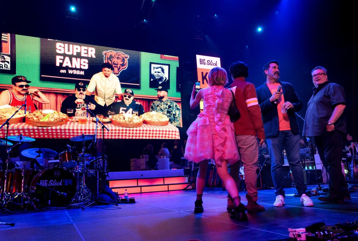 The Big Slick evening began with a video of “Super Fans” of “Da Bears” with, from left, Jason Sudeikis, Robert Smigel and George Wendt, who were joined by Chiefs Patrick Mahomes, standing, and Travis Kelce, far right. Watching from the T-Mobile Center stage were co-hosts Heidi Gardner, from left, Paul Rudd, Rob Riggle and Eric Stonestreet.