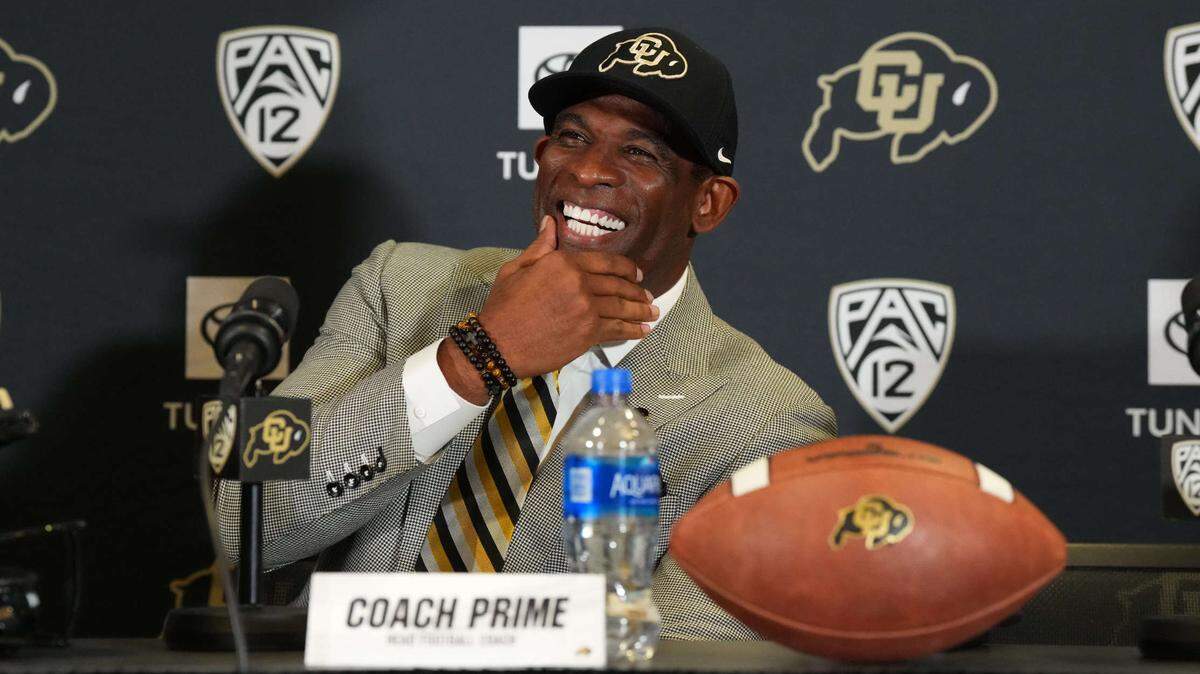 Colorado Buffaloes head coach Deion Sanders reacts during a press conference at the Arrow Touchdown Club on Dec. 4, 2022.