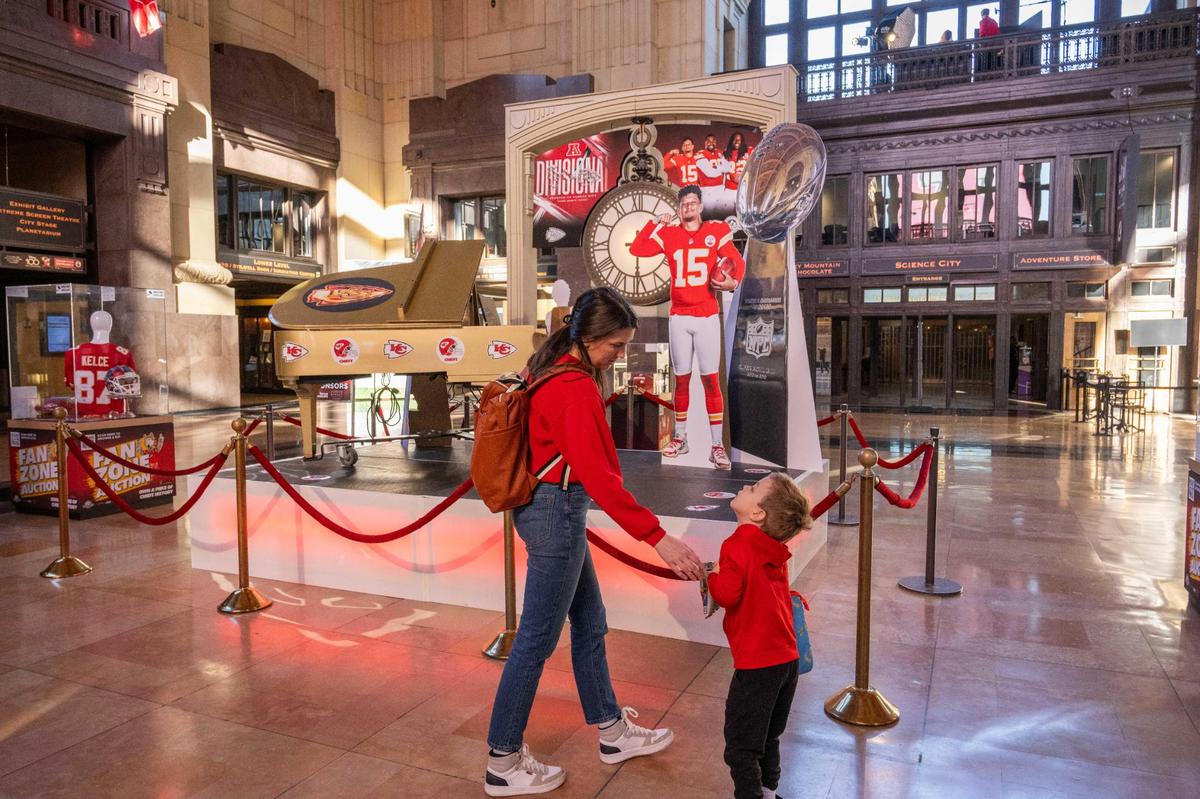Andrea Marks and Henry Marks, 4, take in the newest Chiefs Fan Zone installment at Union Station in Kansas City on Friday, Jan. 17, 2025. It featured several cutouts of players, various selfie stations, and replicas of the Chiefs championship rings.
