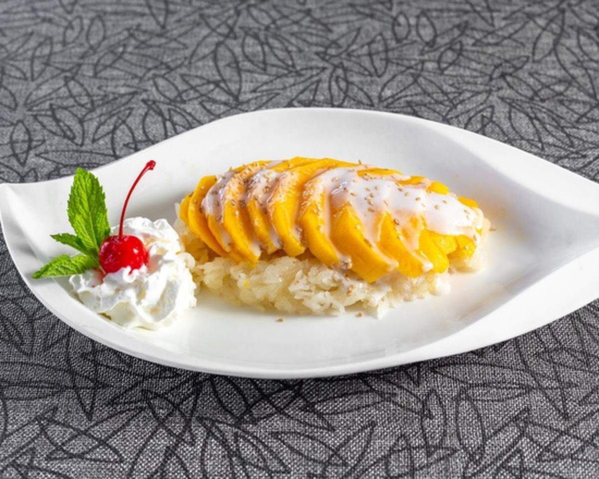 Bamboo Penny’s Sweet Sticky Rice Mango dessert with a coconut cream sauce on fresh mango.