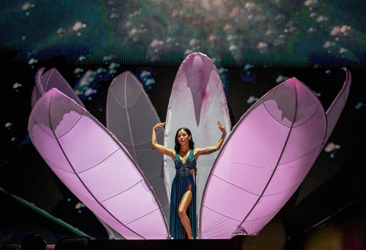 R&B artist Jhené Aiko opens “The Magic Hour” concert at the T-Mobile Center emerging from a human-sized flower wearing an emerald green dress.