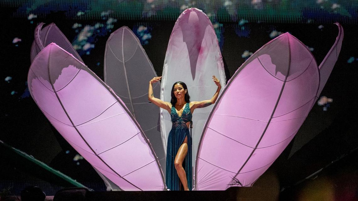 R&B artist Jhené Aiko opens “The Magic Hour” concert at the T-Mobile Center emerging from a human-sized flower wearing an emrald green dress.
