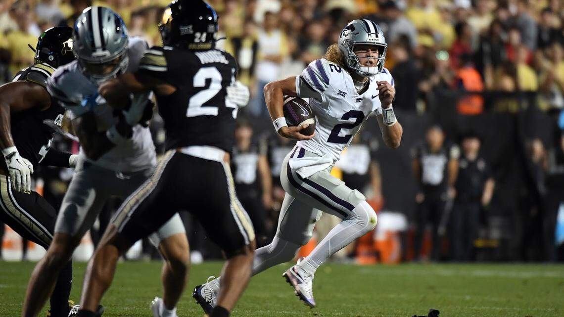 Kansas State Wildcats quarterback Avery Johnson, right, scrambles out of the pocket during Saturday night’s Big 12 football game against the Colorado Buffaloes at Folsom Field in Boulder, Colo.