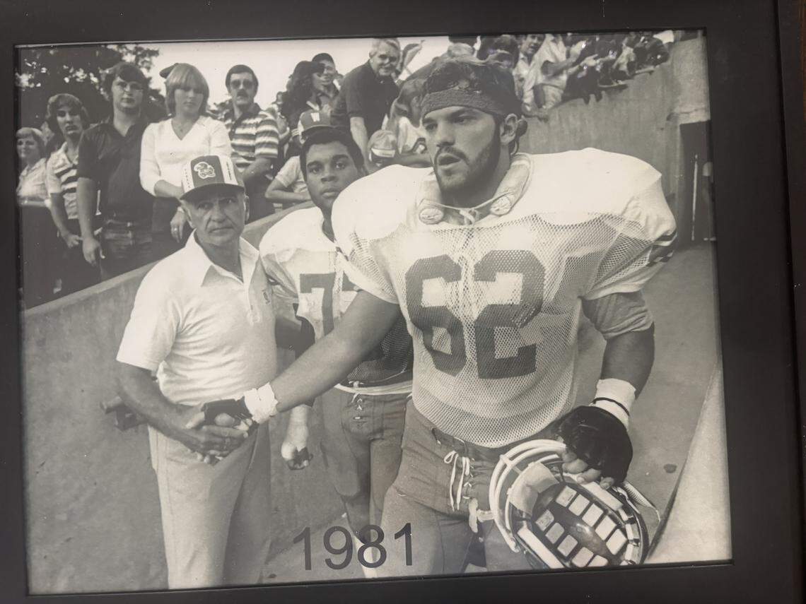 Don Fambrough, left, is with KU team captains David Lawrence, right, and Greg Smith, middle, prior to the coin toss before the KU-Tulsa nonconference football game in 1981.