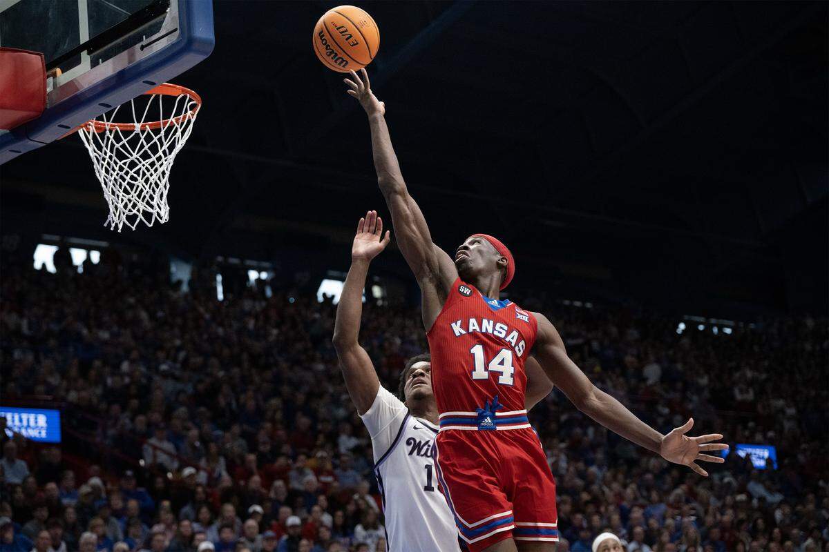 Kansas Jayhawks guard Melvin Council Jr. (14) goes up for a shot as Kansas State Wildcats guard Mobi Ikegwuruka (14) defends in the first half at Allen Fieldhouse on Saturday, March 7, 2026, in Lawrence, Kansas.