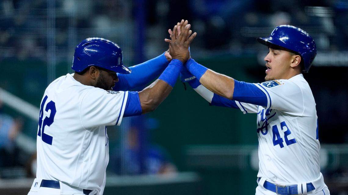 Kansas City Royals’ Hanser Alberto, left, and Nicky Lopez celebrate after they scored when Whit Merrifield reached on a fielding error by Toronto Blue Jays’ Cavan Biggio during the fourth inning of a baseball game Thursday, April 15, 2021, in Kansas City, Mo. (AP Photo/Charlie Riedel)