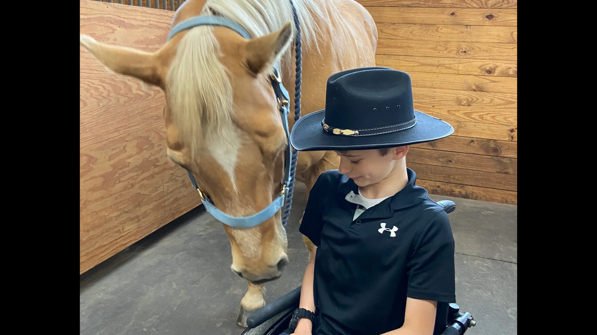 Cowboy Anderson Strom hangs out with his horse buddy at Heartland Therapeutic Riding, a Johnson County non-profit.