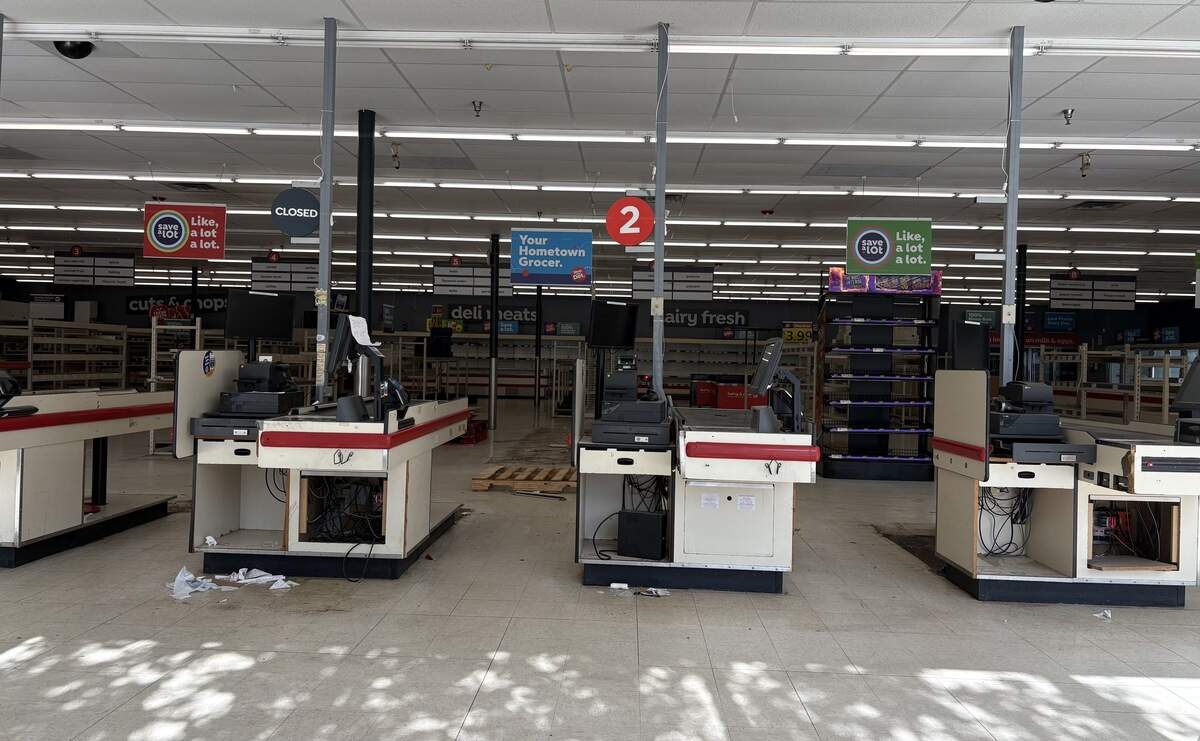 Abandoned cash registers and empty shelves were left inside the former Save-A-Lot grocery store at 3410 Troost Ave., as seen from the front window. June 30, 2026.