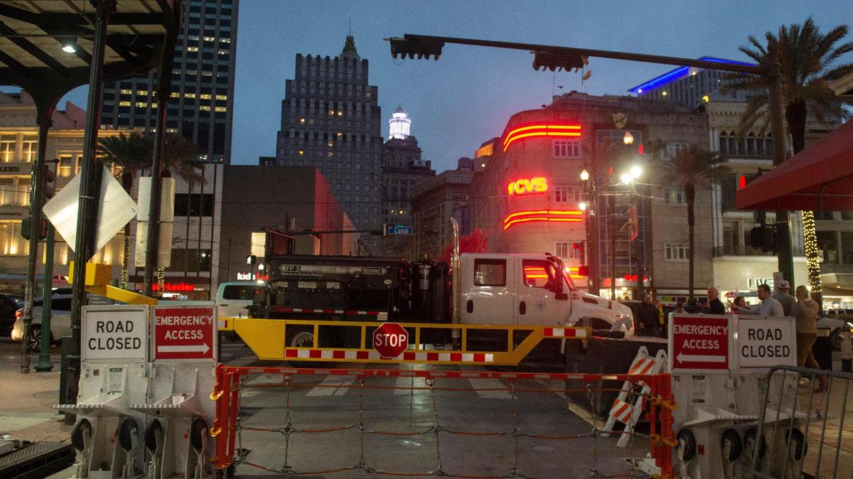Barriers stop vehicles from entering at the intersection of Bourbon Street and Canal Street in New Orleans on Thursday. Fourteen people were killed on Jan. 1 when a man drove a pickup truck around a vehicle parked at the intersection and into a crowd. Ahead of the Super Bowl, the Bourbon Street area will become a security zone with checkpoints, bag searches and more.