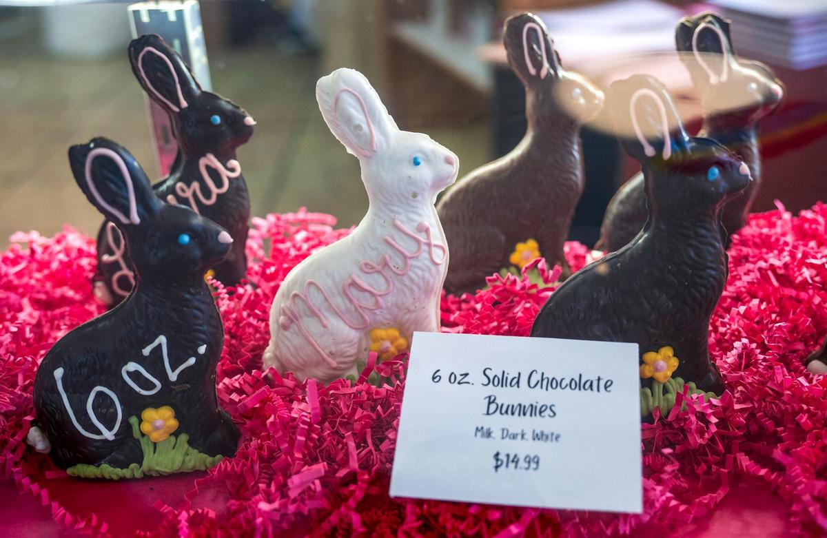 A display case features a variety of chocolate Easter bunnies, which are handmade in house.