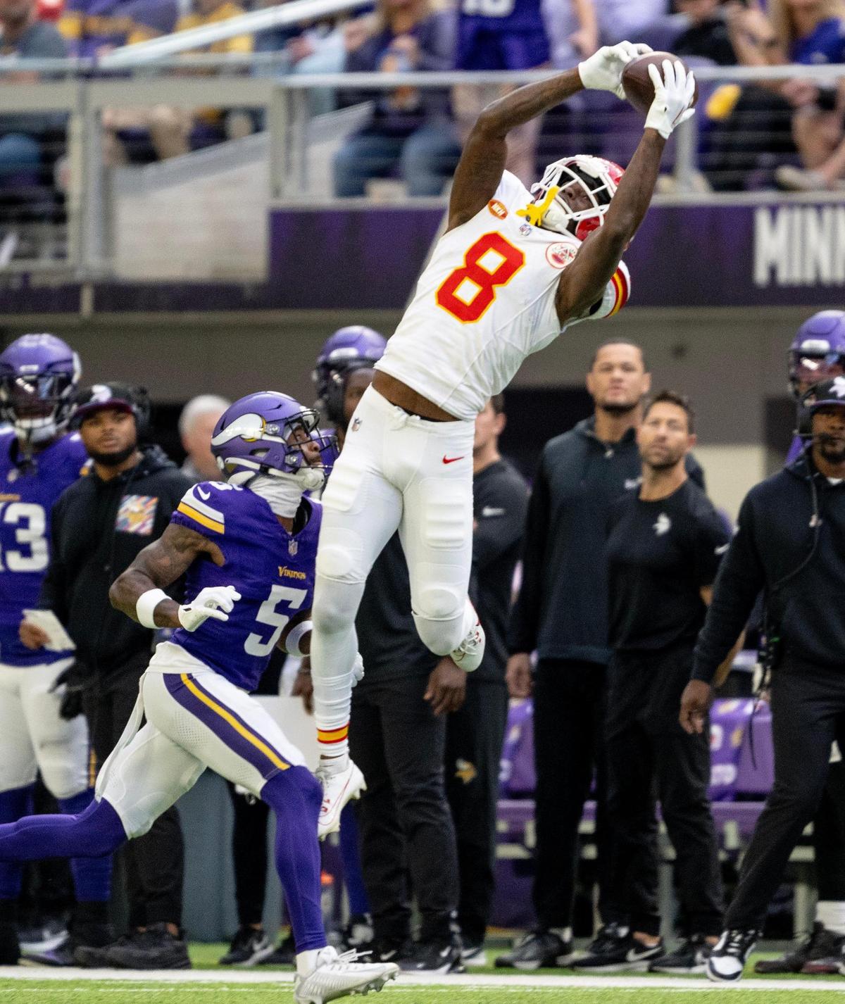 Kansas City Chiefs wide receiver Justyn Ross (8) catches a pass over Minnesota Vikings cornerback Mekhi Blackmon (5) during an NFL football game on Sunday, Oct. 8, 2023, at U.S. Bank Stadium in Minneapolis, Minn.