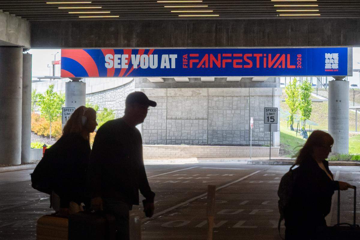 A FIFA Fan Festival sign hangs over the arrival traffic lane at Kansas City International Airport, on Wednesday, April 29, 2026.