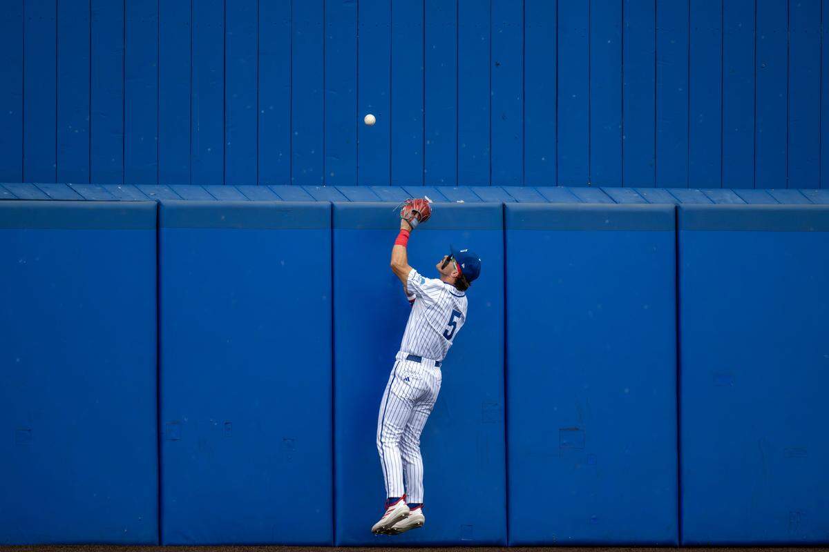 Kansas Jayhawks utility Tyson Owens (5) misses a catch on a hit by Northeastern Huskies outfielder Ryan Gerety (3) in the fifth inning of an NCAA baseball tournament game at Hoglund Ballpark on Friday, May 29, 2026, in Lawrence.