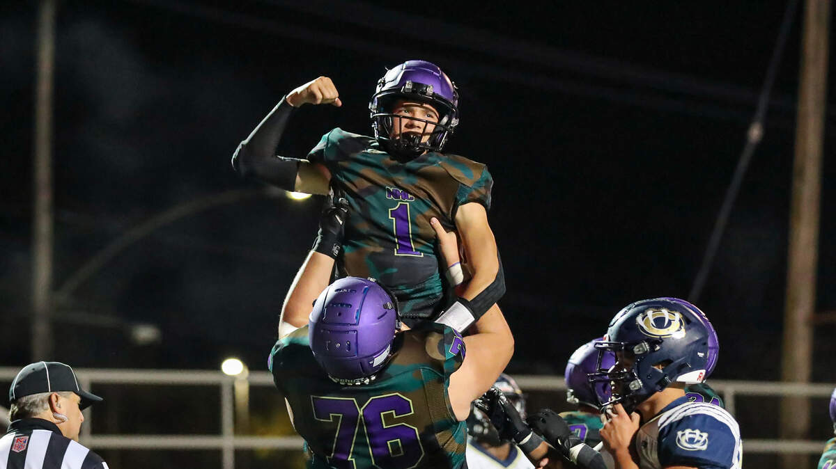North Kansas City’s Christopher Johnson (No. 1) celebrates a touchdown with teammate Kaden Cowling (76) during Friday night’s game against William Chrisman.
