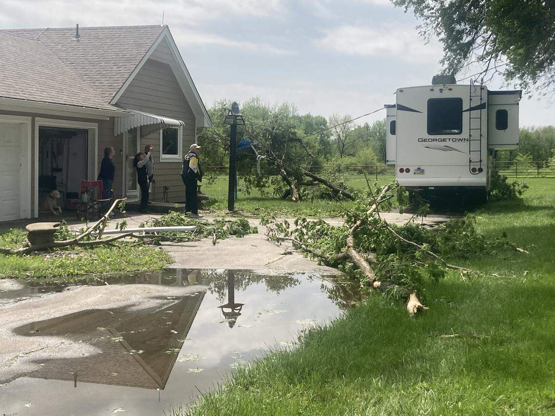 Downed power lines and branches ripped from trees lie across Marla Burvee’s property in Spring Hill, Kansas, following a severe thunder and lightning storm on Sunday, April 26 and Monday, April 27, 2026.