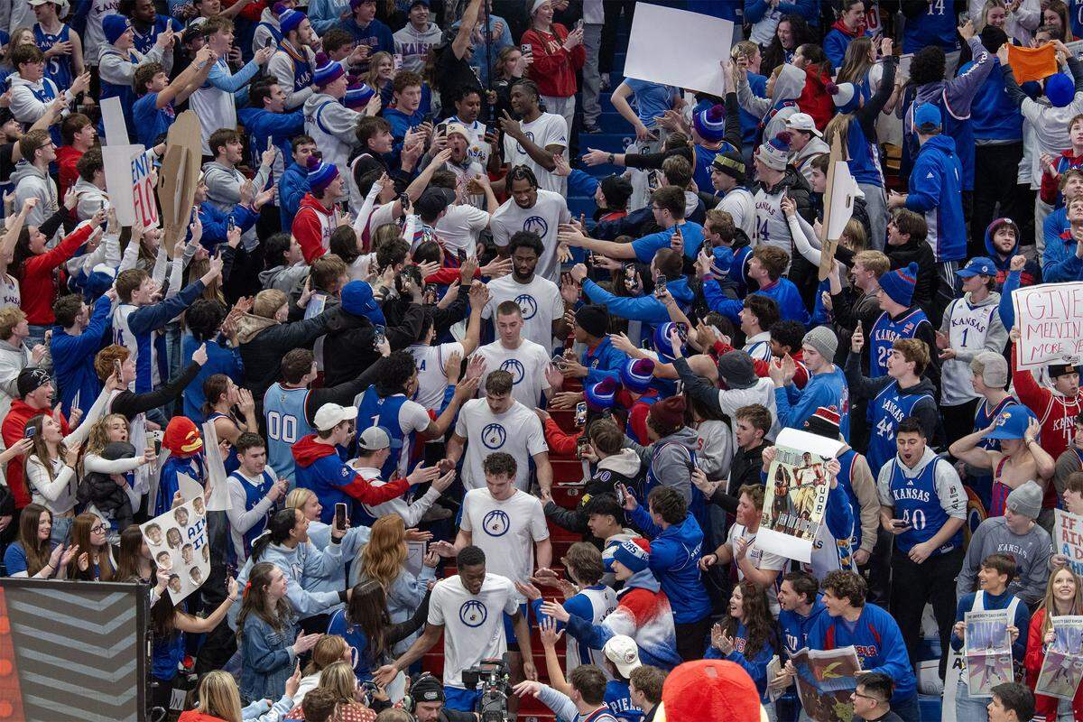 Members of the Kansas Jayhawks basketball team walk through the stands during ESPN College Gameday at Allen Fieldhouse on Saturday, Jan. 31, 2026, in Lawrence.